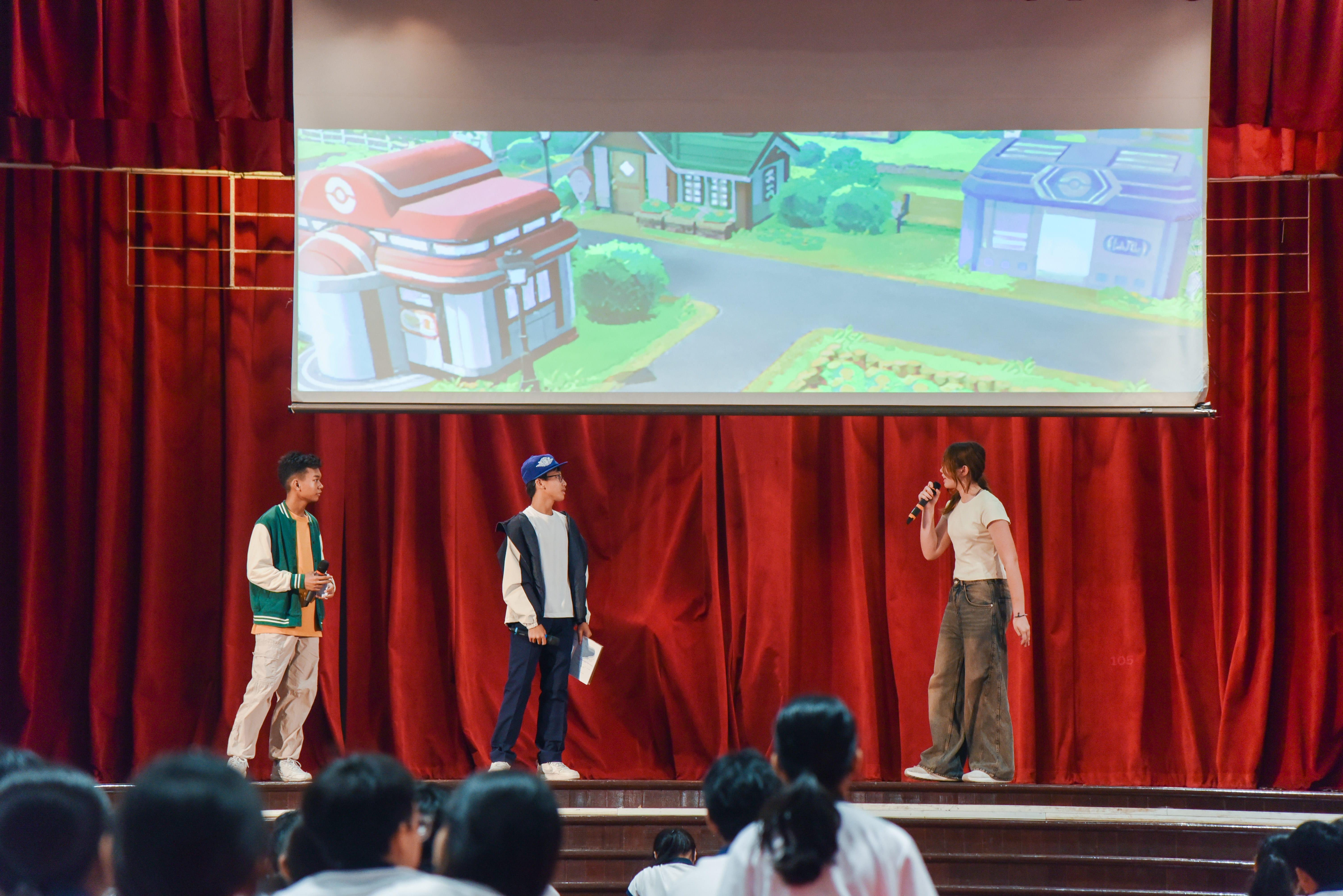 Students onstage holding a skit